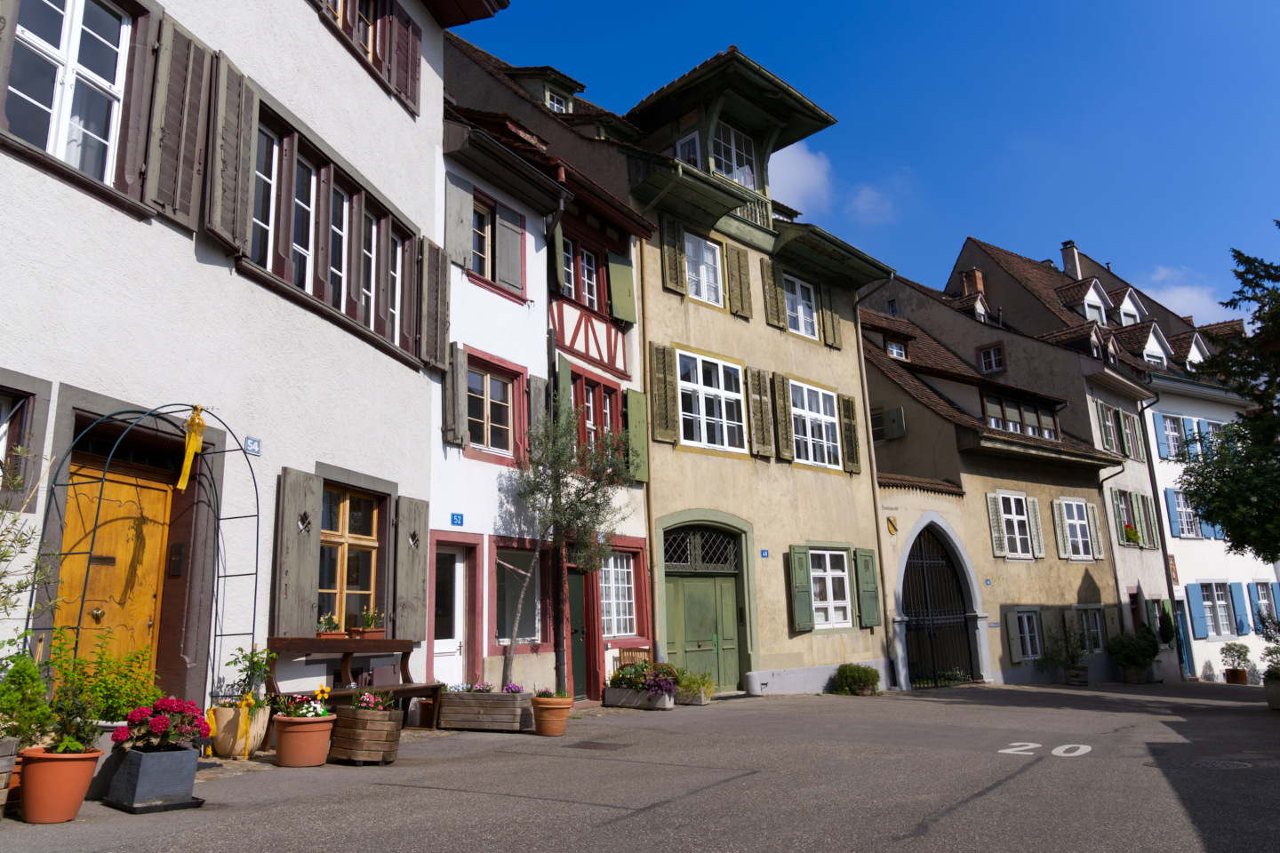 Facades of historic houses at the medieval old town of Basel on a blue cloudy spring day. iStock 1395546549 24